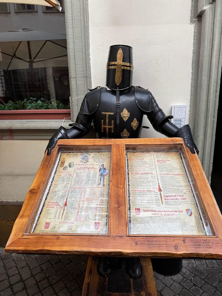 A person in armor holding a menu board

AI-generated content may be incorrect.