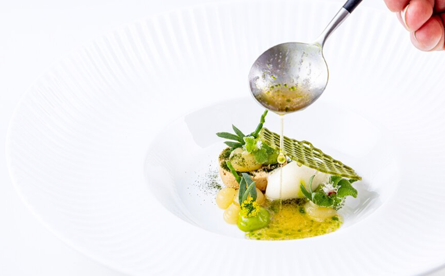 A spoon pouring liquid onto a plate of food

AI-generated content may be incorrect.