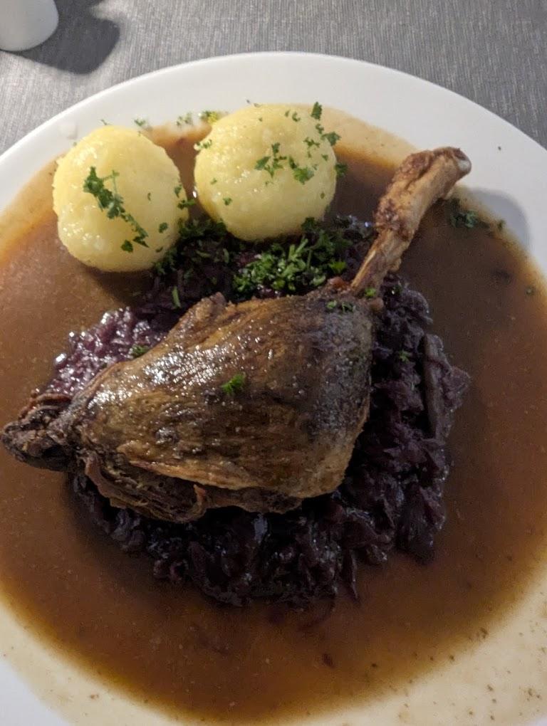 A plate of food with meat and potatoes

AI-generated content may be incorrect.